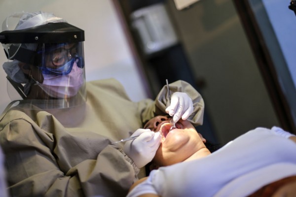 COVID-19 Aerosol Concentration on Dental Clinics Depends on the Room's Orientation